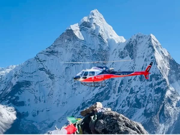 Returen Helicopter Flying Over Amadablam During Everest Trek